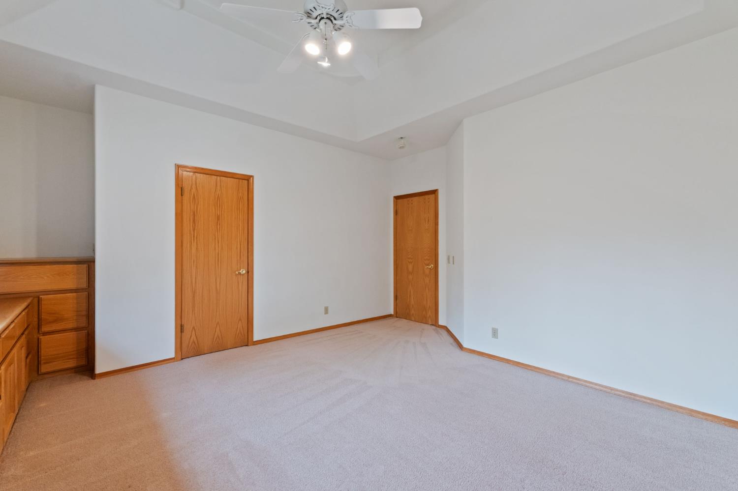 7357 East Dennett Avenue Fresno, CA 93737 - Photo 37 of 84 an empty room with a ceiling fan and closet area