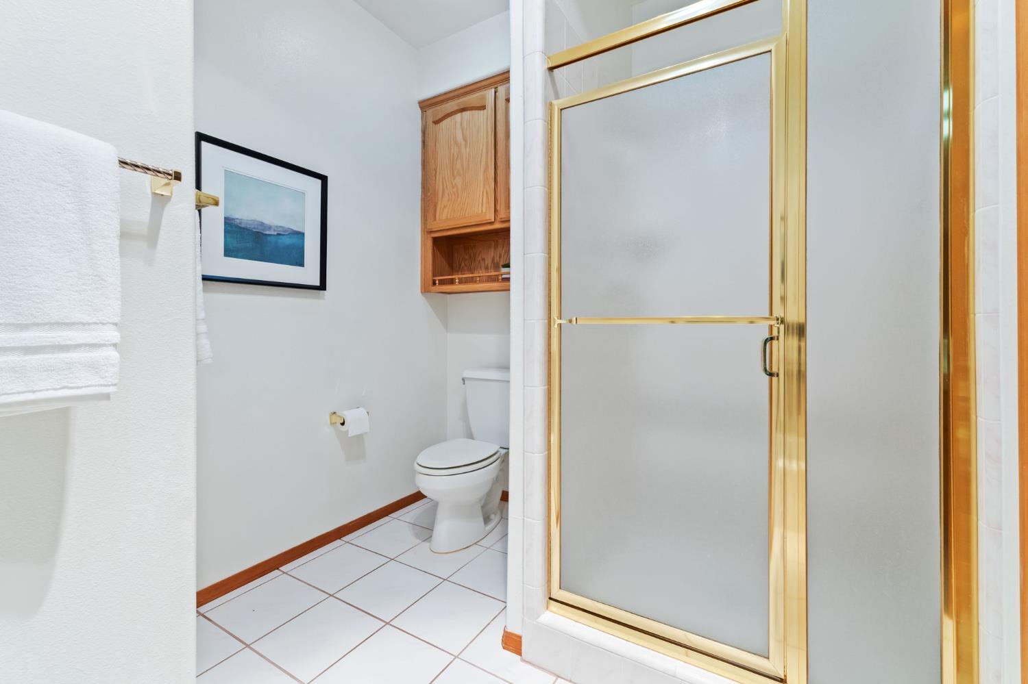 7357 East Dennett Avenue Fresno, CA 93737 - Photo 39 of 84 a bathroom with a toilet and a shower