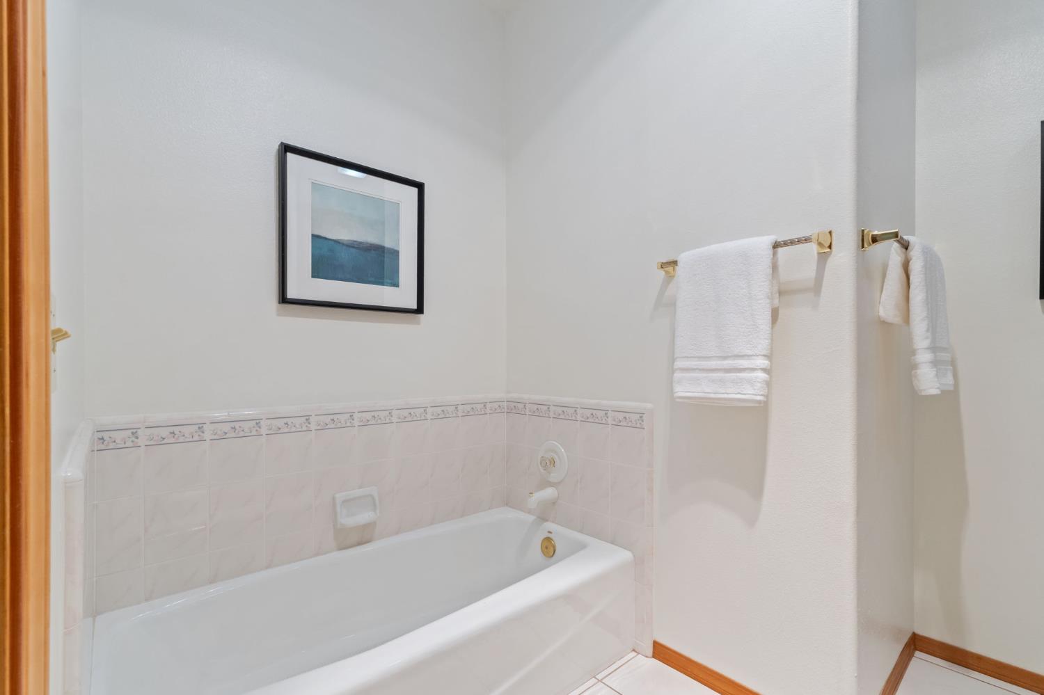 7357 East Dennett Avenue Fresno, CA 93737 - Photo 40 of 84 a bathroom with a bathtub