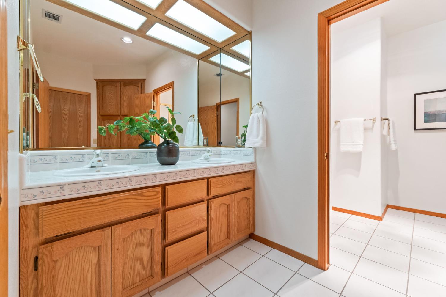7357 East Dennett Avenue Fresno, CA 93737 - Photo 41 of 84 a bathroom with a double vanity sink and a mirror
