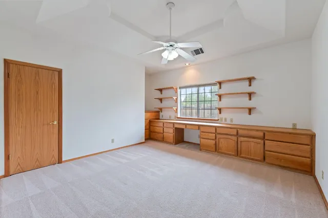an aerial view of a house with a garden and a yard