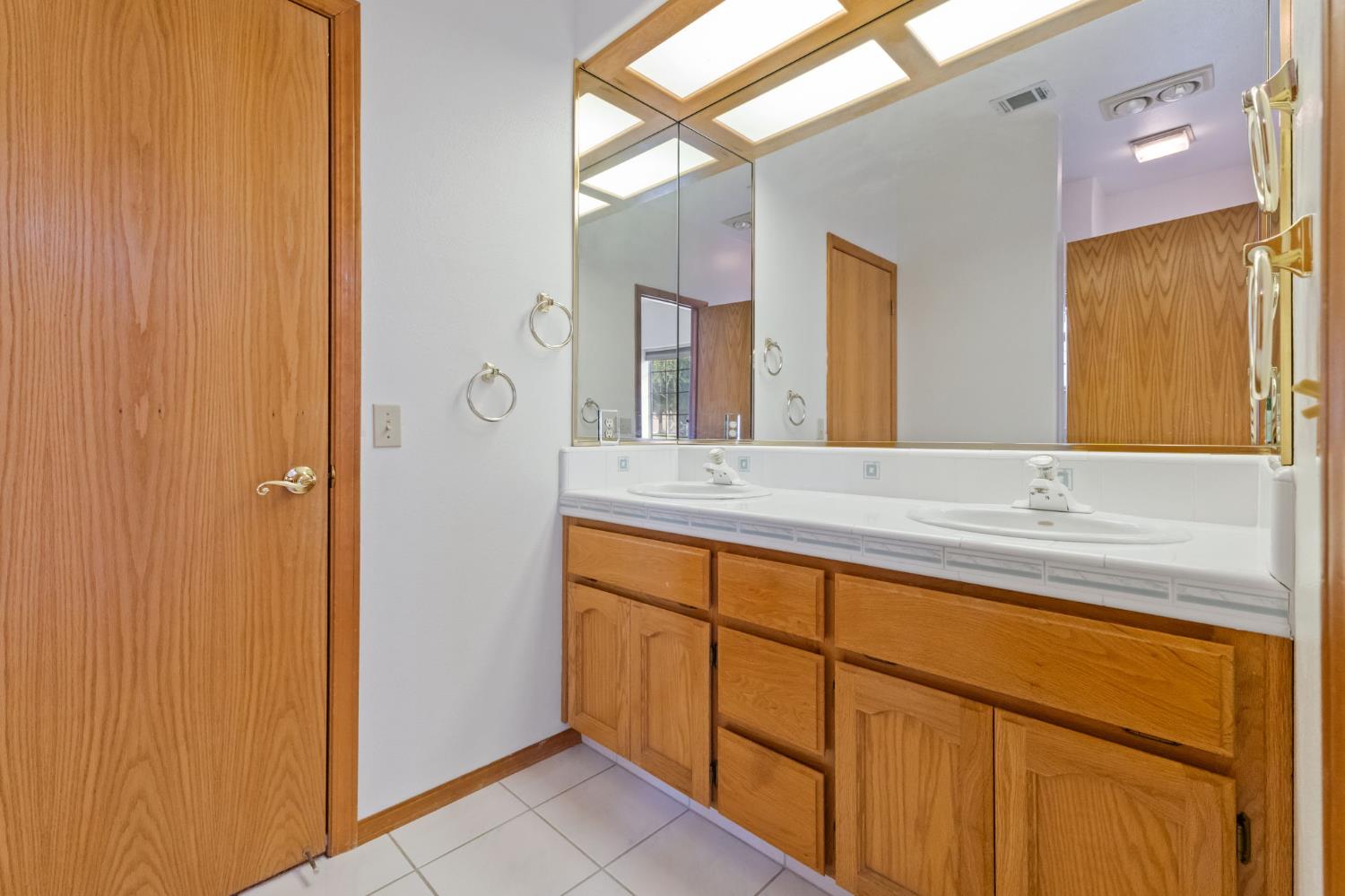7357 East Dennett Avenue Fresno, CA 93737 - Photo 47 of 84 a bathroom with a granite countertop sink and a mirror