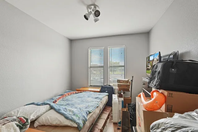 a bedroom with bed and windows