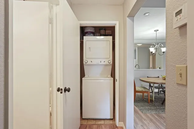 a view of a hallway with bathroom and wooden floor