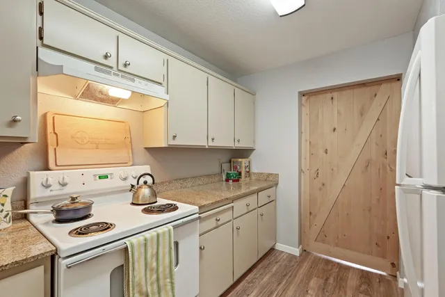 a kitchen with a sink stove and cabinets