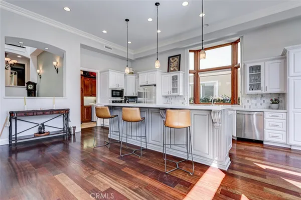 a view of a room with wooden floor and chandelier