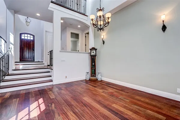 a view of entryway and hall with wooden floor