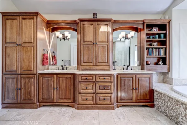 a bathroom with a tub a sink and large window
