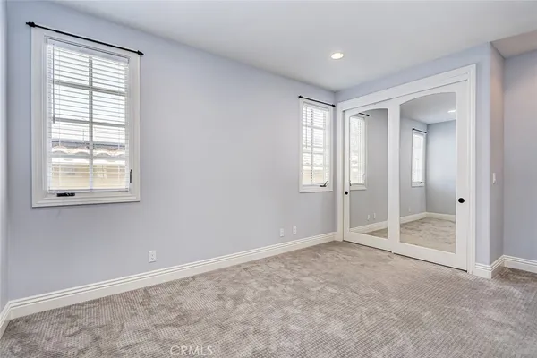 a bathroom with double sink and a mirror