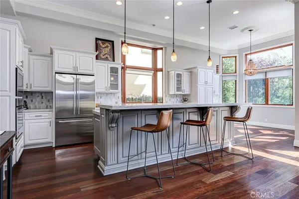 a kitchen with stainless steel appliances granite countertop a stove a sink and a refrigerator