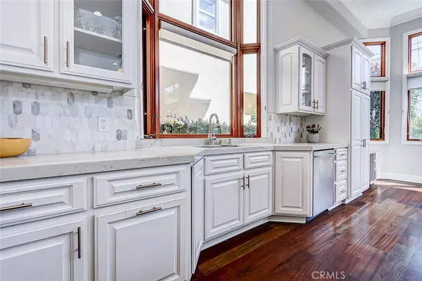 a large kitchen with stainless steel appliances a lot of counter space and a large window