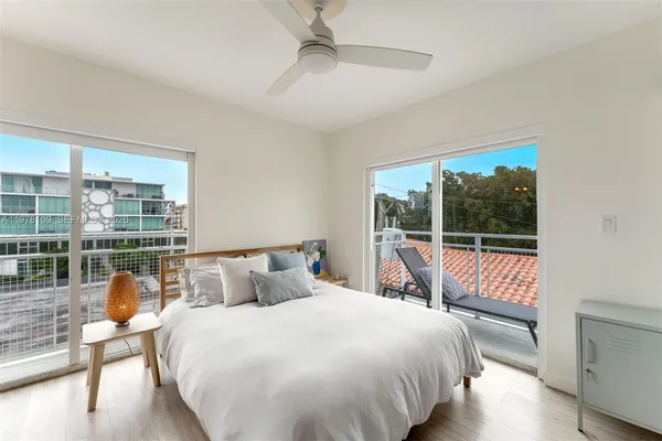 a bedroom with a large bed and a large window
