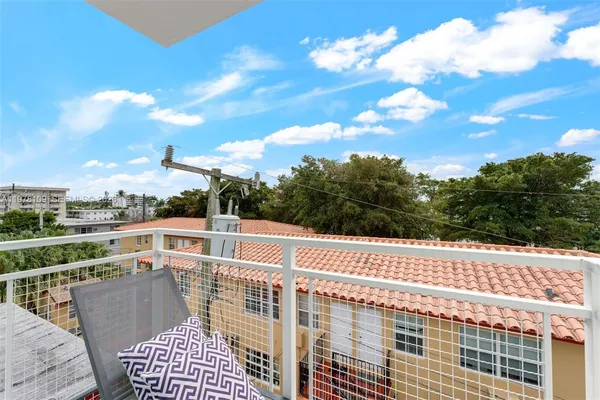 a view of balcony with wooden floor and city view