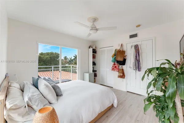 a bedroom with bed and a window