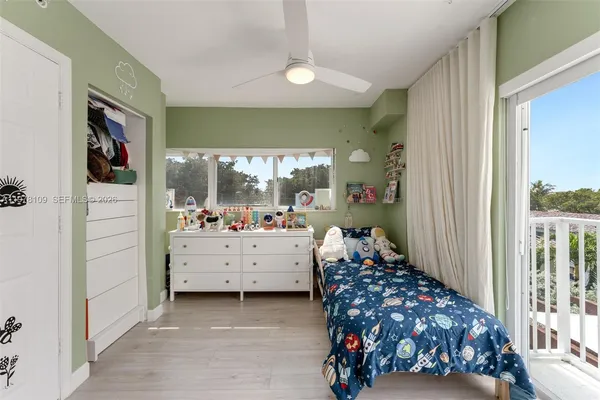 a bedroom with bed and a large window