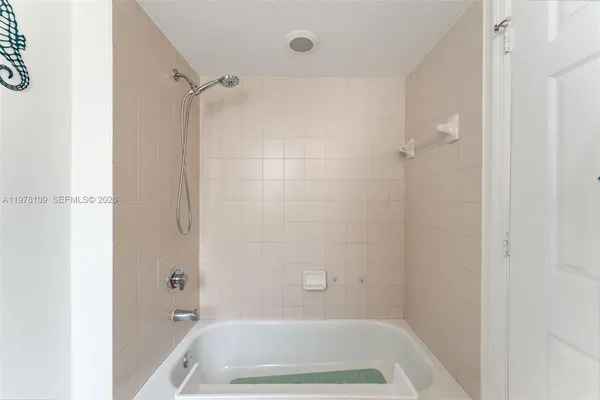 a bathroom with a tub and shower
