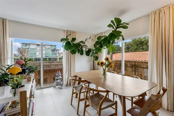 a view of a dining room with furniture and window