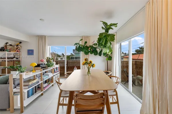 a view of a dining room with furniture window and flowerpot