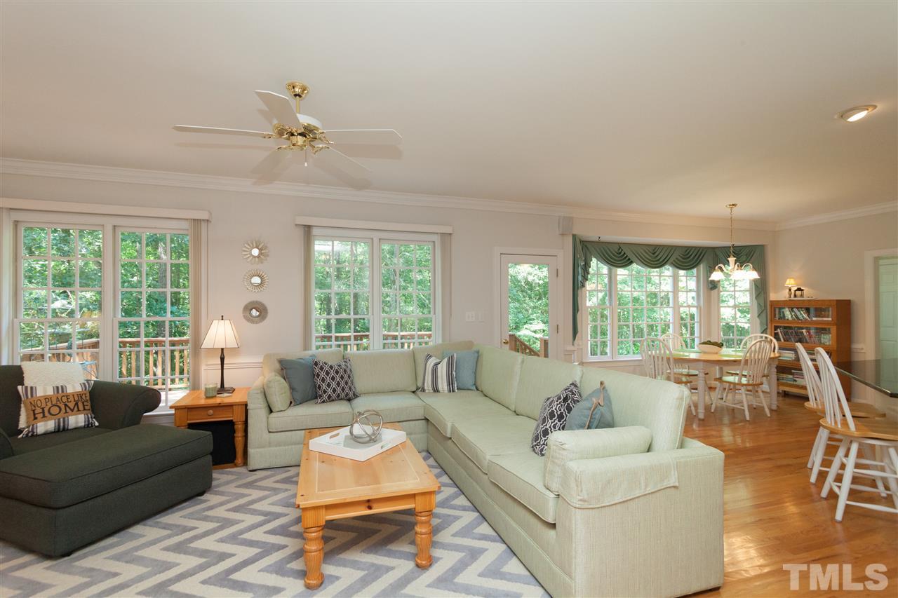 4124 Ridgebrook Bluffs Drive Raleigh, NC 27603 - Photo 8 of 24 The heart of the home! Open to the kitchen, fireplace and crown molding. Wall of windows provide natural light and pretty views of the property.
