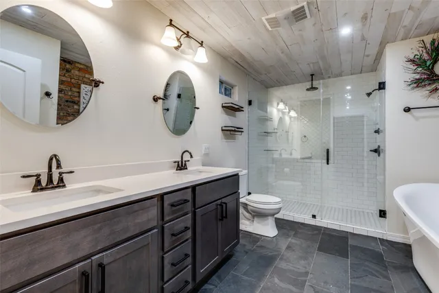 a bathroom with a toilet sink and shower