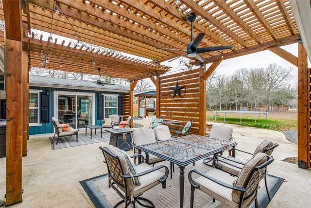 a view of a house with a yard and large tree