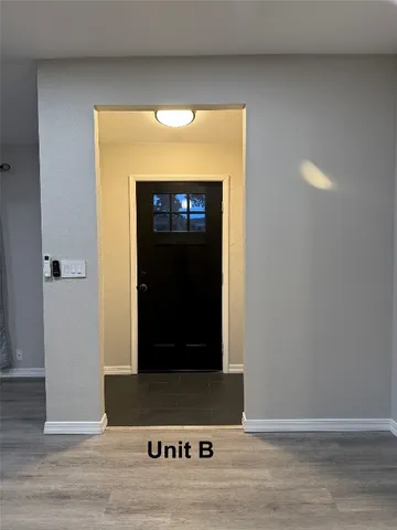 a kitchen with a table chairs refrigerator and microwave