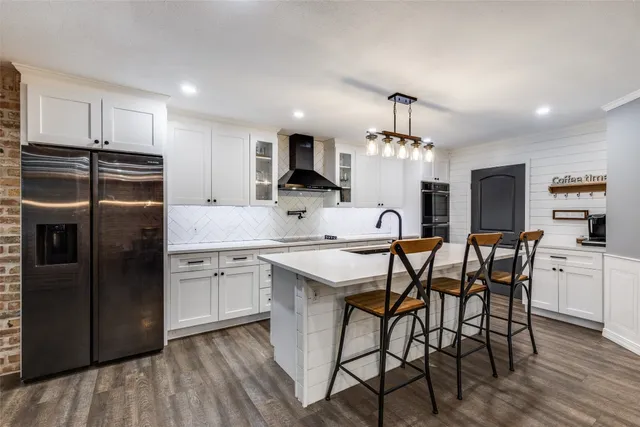 a large kitchen with a table and chairs