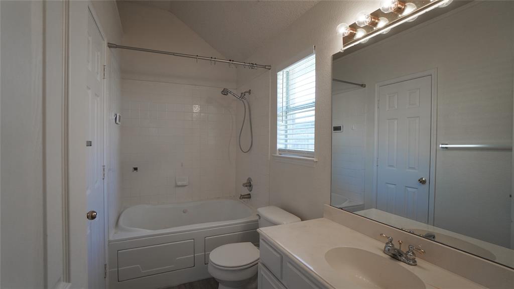 137 Magnolia Lane Rockwall, TX 75032 - Photo 17 of 28 a bathroom with a sink a toilet and shower