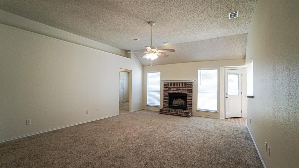137 Magnolia Lane Rockwall, TX 75032 - Photo 7 of 28 an empty room with fireplace and windows
