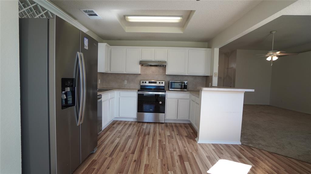 137 Magnolia Lane Rockwall, TX 75032 - Photo 9 of 28 a kitchen with a sink and wooden floor