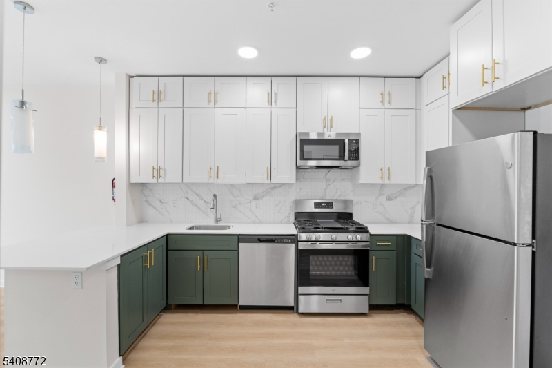 321 East 3rd Street, Unit 210 Plainfield, NJ 07060 - Photo 24 of 43 a kitchen with stainless steel appliances a stove a sink and a refrigerator