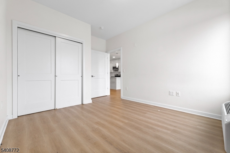 321 East 3rd Street, Unit 210 Plainfield, NJ 07060 - Photo 26 of 43 a view of an empty room with wooden floor