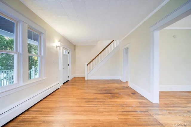a view of a room with wooden floor