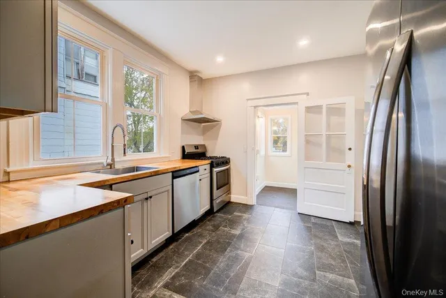 a kitchen with a refrigerator and a sink
