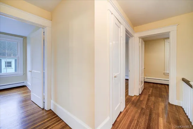 a view of entryway with wooden floor and stairs