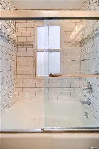 a bathroom with a sink a toilet a mirror and bathtub
