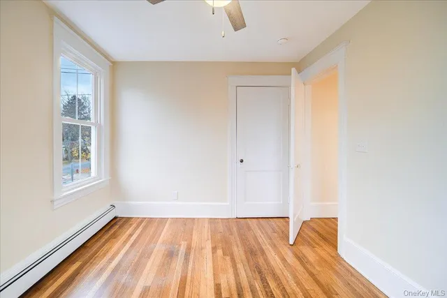 a view of room with window and wooden floor