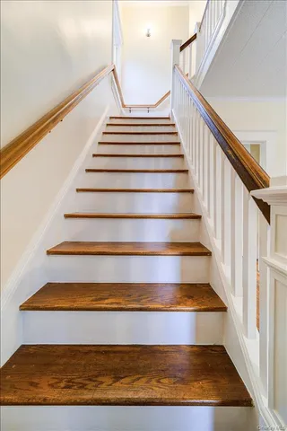 a view of a room with wooden floor and a window