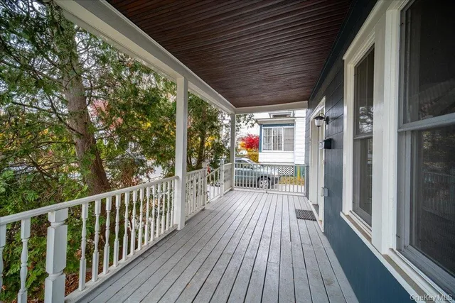 a view of a balcony with wooden floor