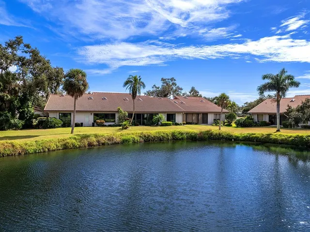a view of a house with swimming pool and a yard