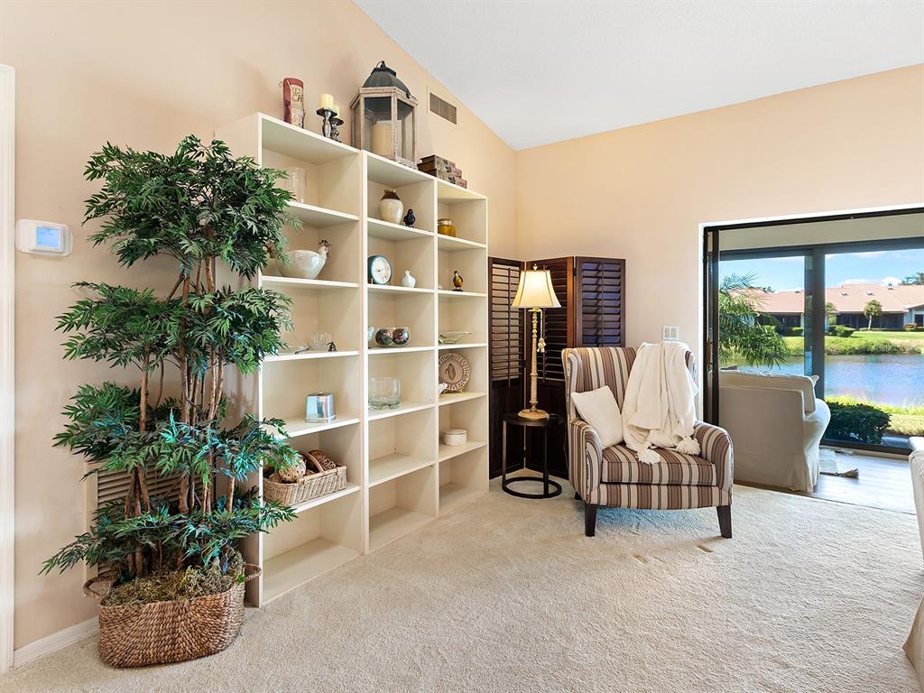 6094 Wilshire Boulevard, Unit 8 Sarasota, FL 34233 - Photo 14 of 42 a bed room with a bed and a potted plant