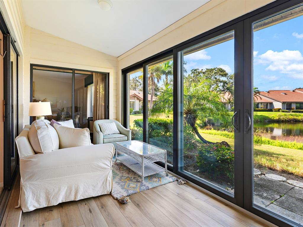 6094 Wilshire Boulevard, Unit 8 Sarasota, FL 34233 - Photo 26 of 42 a living room with couch and a large window