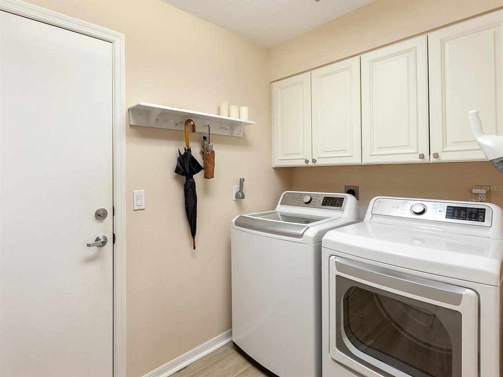 6094 Wilshire Boulevard, Unit 8 Sarasota, FL 34233 - Photo 29 of 42 a utility room with dryer and washer