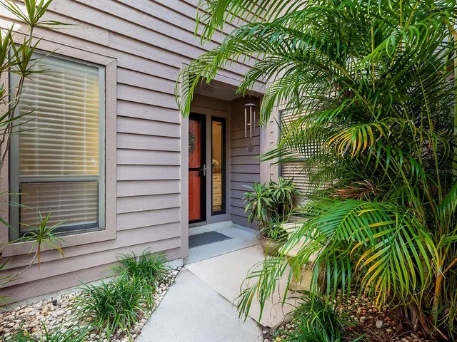 a view of a hallway with wooden floor and entryway