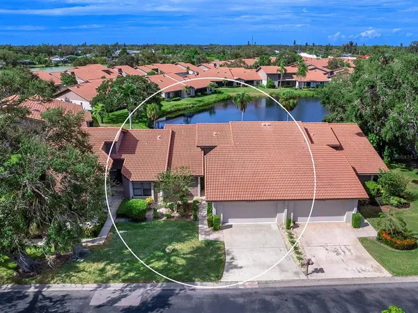 an aerial view of a house with a yard and outdoor seating