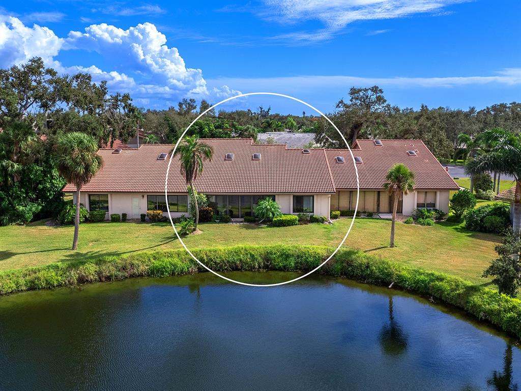 6094 Wilshire Boulevard, Unit 8 Sarasota, FL 34233 - Photo 37 of 42 a view of a house with a yard