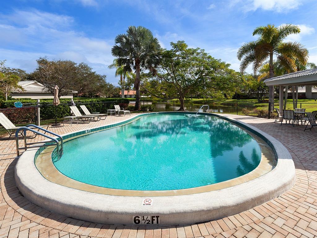 6094 Wilshire Boulevard, Unit 8 Sarasota, FL 34233 - Photo 38 of 42 a view of a swimming pool with a yard
