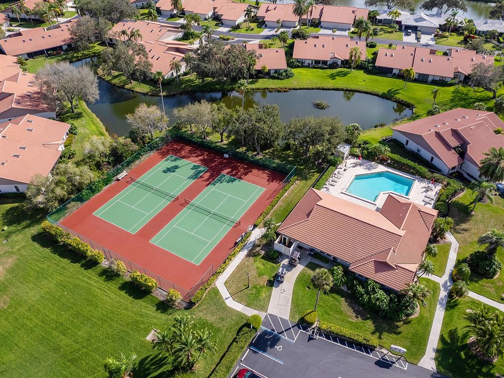6094 Wilshire Boulevard, Unit 8 Sarasota, FL 34233 - Photo 41 of 42 an aerial view of a house with a garden and lake view