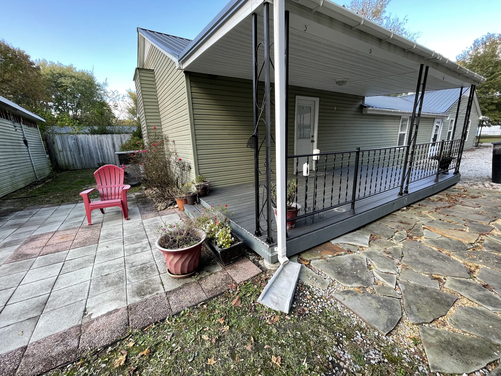 312 Gentry Street Tullahoma, TN 37388 - Photo 25 of 29 a view of a backyard with table and chairs potted plants and wooden fence