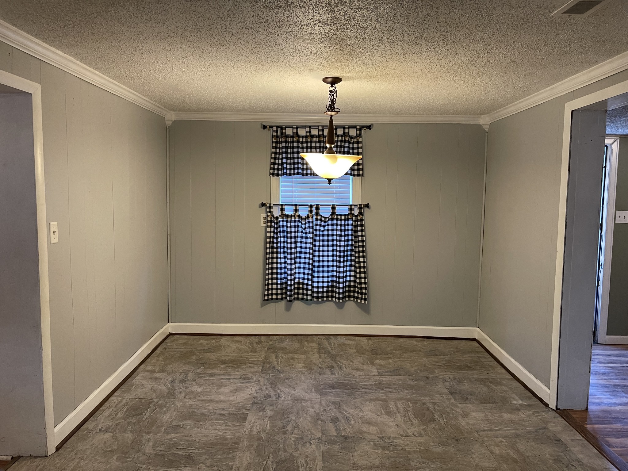 312 Gentry Street Tullahoma, TN 37388 - Photo 9 of 29 an empty room with a ceiling fan and window